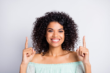 Wall Mural - Photo portrait of woman pointing two fingers up at blank space isolated on white colored background