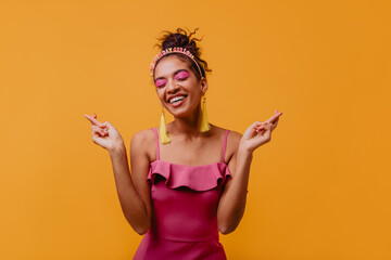 Slim african girl with pink makeup enjoying party. Graceful black woman celebrating her birthday.