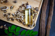 © Alongkorn - Oil of Moringa in bottle, green leaves, pods and seeds on wooden background. Moringa oleifera tropical herb product concept.