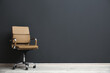 © New Africa - Comfortable office chair near black wall indoors. Space for text