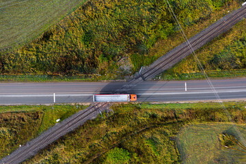 aerial top down view on railroad crossing with asphalt road