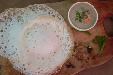 Wall Mural - Rice pancake or Hoppers locally called Appam served with Chicken and potatoes simmered in coconut milk 