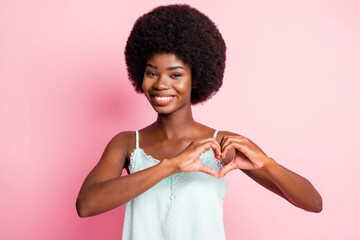 Sticker - Photo of happy brown haired young woman make hands heart shape romantic mood isolated on pink color background