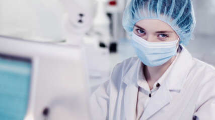 Wall Mural - female scientist testing biohazardous samples, futuristic laboratory interior