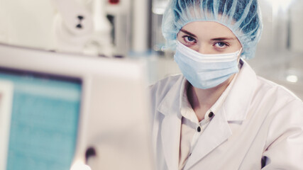 Wall Mural - female scientist testing biohazardous samples, futuristic laboratory interior