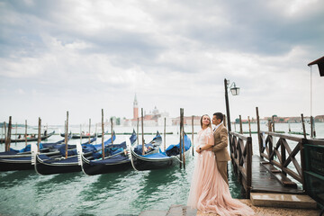 Wall Mural - Wedding couple on the nature is hugging each other. Beautiful model girl in white dress. Man in suit.Venice, Italy