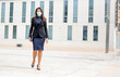 © JoseLuis - Elegant attractive girl walking on the street with protective mask