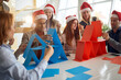 © luckybusiness - blue and red team competing in building card towers at the office for christmas