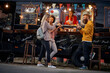 © luckybusiness - group young adult friends having fun while eating in front of modified truck for mobile fast food service