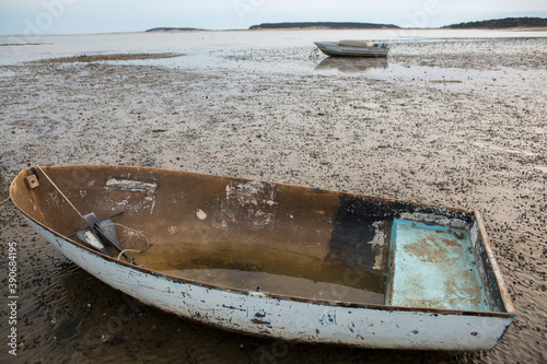 Fotografía Two wooden boats on beach at low tide in Wellfleet, MA on Cape Cod