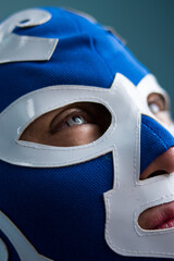 Wall Mural - Close up of blue eyed man wearing  a blue wrestling mask