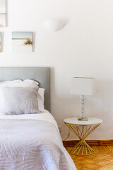 Side table with white lamp in the bedroom