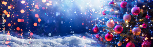 Fotomural Abstract Snowy Christmas Tree On Snow With Snowfall And Defocused Lights In The