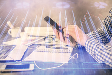 Aufkleber - Double exposure of man's hands holding and using a digital device and forex graph drawing. Financial market concept.