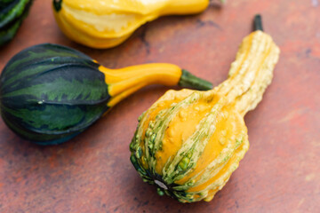 Canvas Print - Top view of yellow and green zucchinis on a dark brown table