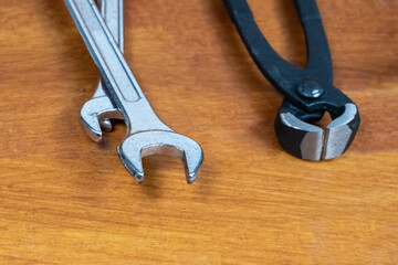 Wall Mural - set of tools for repairing a wrench and wire cutters lies on a wooden table of the master