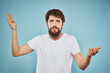 © SHOTPRIME STUDIO - Bearded man emotions white t-shirt lifestyle gestures with hands blue backgrounds