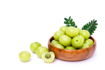 Wall Mural - Closeup Indian gooseberry fruits ( phyllanthus emblica, amla ) in wooden bowl with green leaf and slice isolated on white background. 