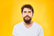 © SHOTPRIME STUDIO - emotional bearded man in t-shirt cropped view yellow background studio