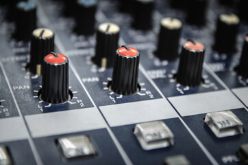 Wall Mural - Audio mixer console and professional sound mixing with buttons and sliders.