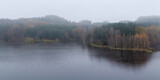 Fototapeta Las - Czech autumn foliage trees landscape on Rimov dam in misty fog