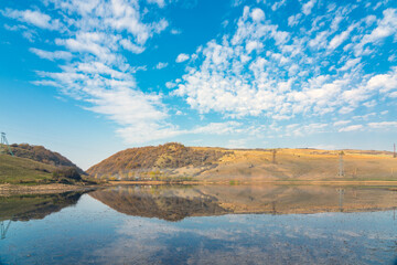 Wall Mural - Clouds reflections in a mountain lake