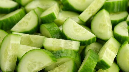 Poster - fresh cucumbers. chopped cucumber rotating