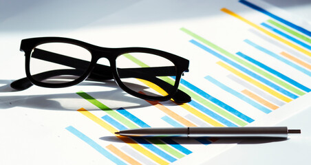 Poster - Business concept with glasses pen and on the documents. Business grafs and charts