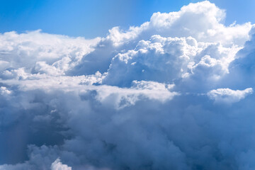 Wall Mural - Aerial view flying above clouds in the atmosphere, depicts heaven. space for text