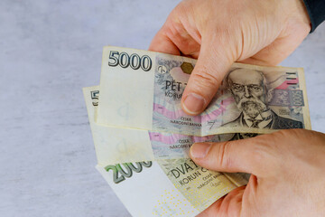 Hand of a man holding czech koruna banknote