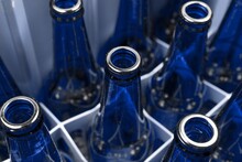 Empty Blue Glass Beer Bottles In The Plastic Box