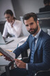 © zinkevych - Young bearded man in tie and suit with documents
