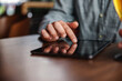 © dusanpetkovic1 - Closeup of man using tablet for hanging on social media while sitting in a bar.