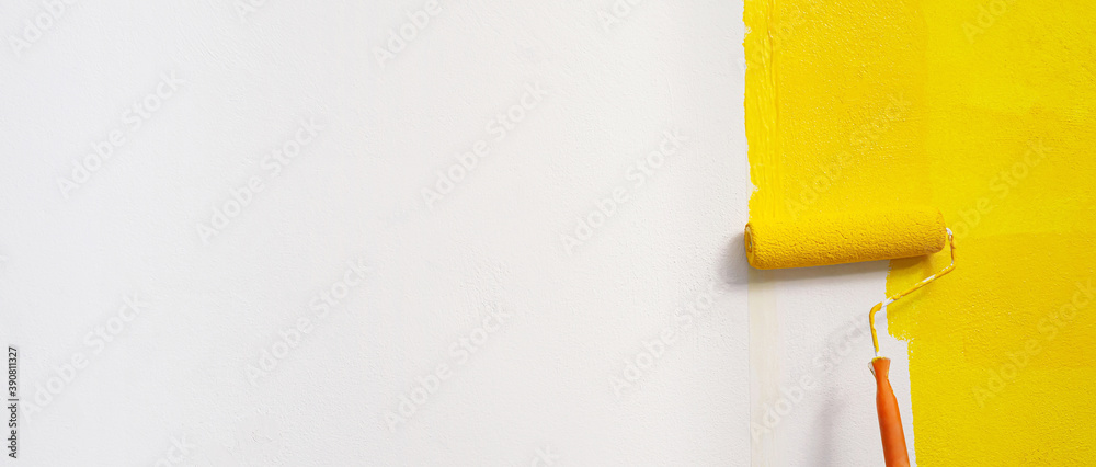 Roller Brush Painting, Worker painting on surface wall  Painting apartment, renovating with yellow color  paint. Leave empty copy space white to write descriptive text beside. - obrazy, fototapety, plakaty 