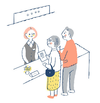 受付窓口　受付係の女性とシニア夫婦