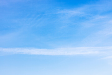 Wall Mural - old blurred contrail and cirrus clouds in blue sky on autumn day