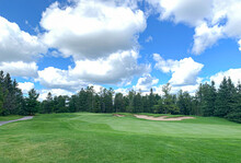 A Green Golf Course And Blue Cloudy Sky On A Beautiful Summer Day In Canada