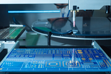 Poster - PCB production using laser equipment. Printed circuit board on a laser machine. PCB is blue during production. Process of creating a printed circuit board. Laser soldering of printed circuit boards