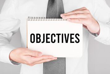 Poster - businessman with notebook with text objectives
