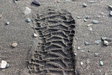 Boot Footprint On Wet Sand.