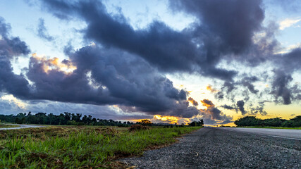 Poster - Beautiful shot of an asphalt road on a beautiful sunset background