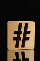 Wooden textured hashtag symbol isolated on the  black background