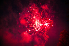 Bright Red Fireworks In The Night Sky