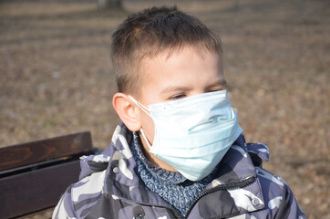 portrait of brunette man in a surgical bandage on a background of a modern building, coronavirus, illness, infection, quarantine, medical mask