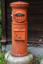 An Historic Orange Letter Box. The Old Red Post Box Pillar. The Ancient Round Mailbox.