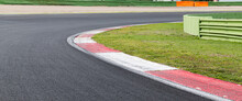 Rough Curb On Asphalt Right Turn Motor Sport Track With Green Field Empty Copy Space