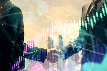 Double exposure of forex graph hologram and handshake of two men. Stock market concept.