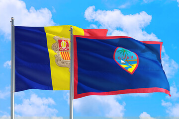 Guam and Andorra national flag waving in the windy deep blue sky. Diplomacy and international relations concept.