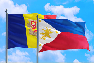 Philippines and Andorra national flag waving in the windy deep blue sky. Diplomacy and international relations concept.