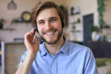 Wall Mural - Male customer support operator with headset and smiling.